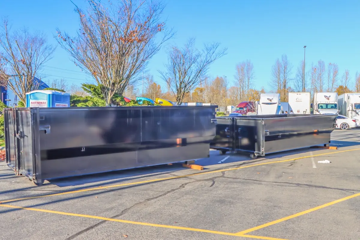 Professional dumpster rental service with roll-off container on residential driveway in Gautier